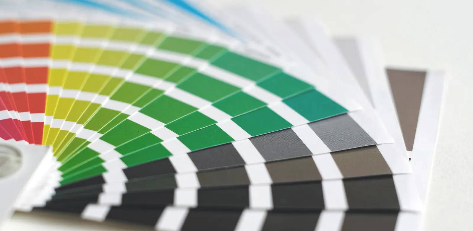 A fanned-out Pantone swatch book used to match ink colors.